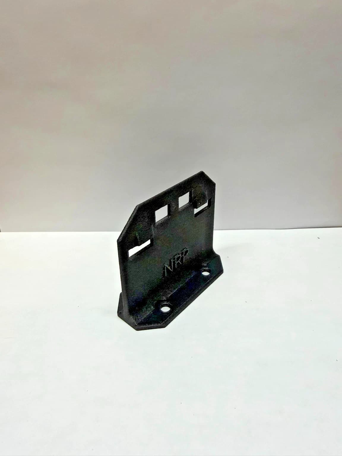Angled view of the NRP-SP-001 refrigerator flapper strike plate